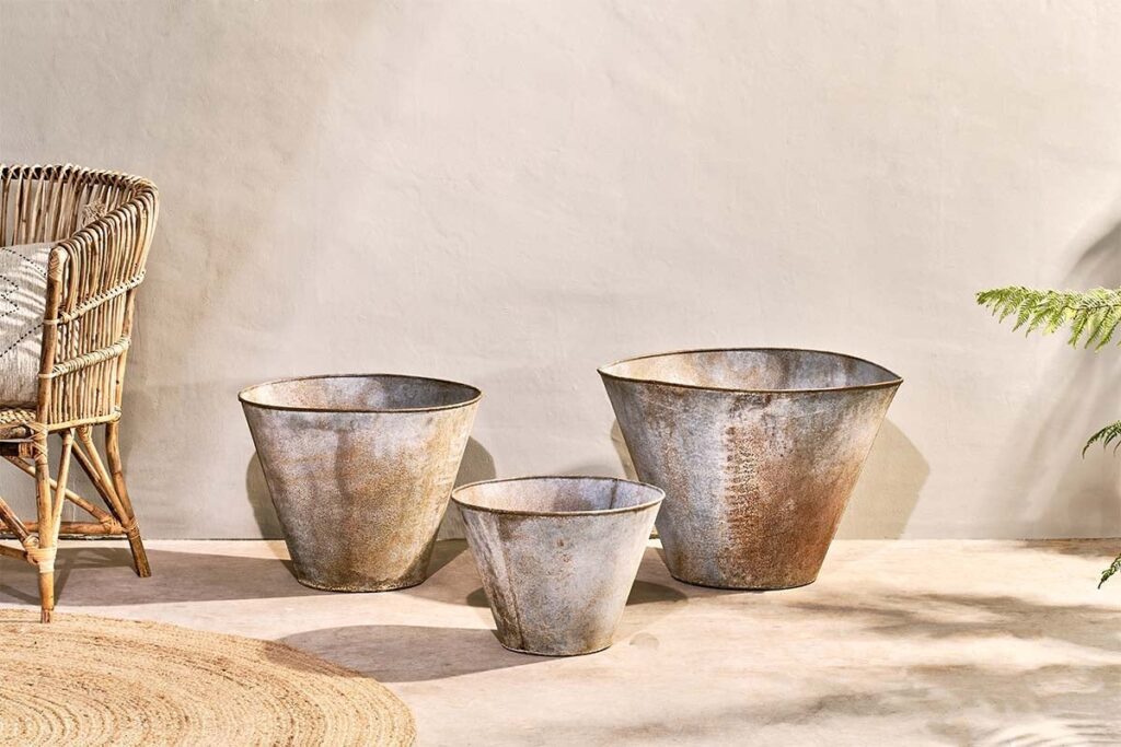 3 nkuku abari tapered planters against a cream coloured wall